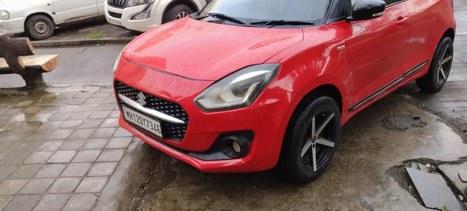 Red hatchback photographed from the opposite side and front